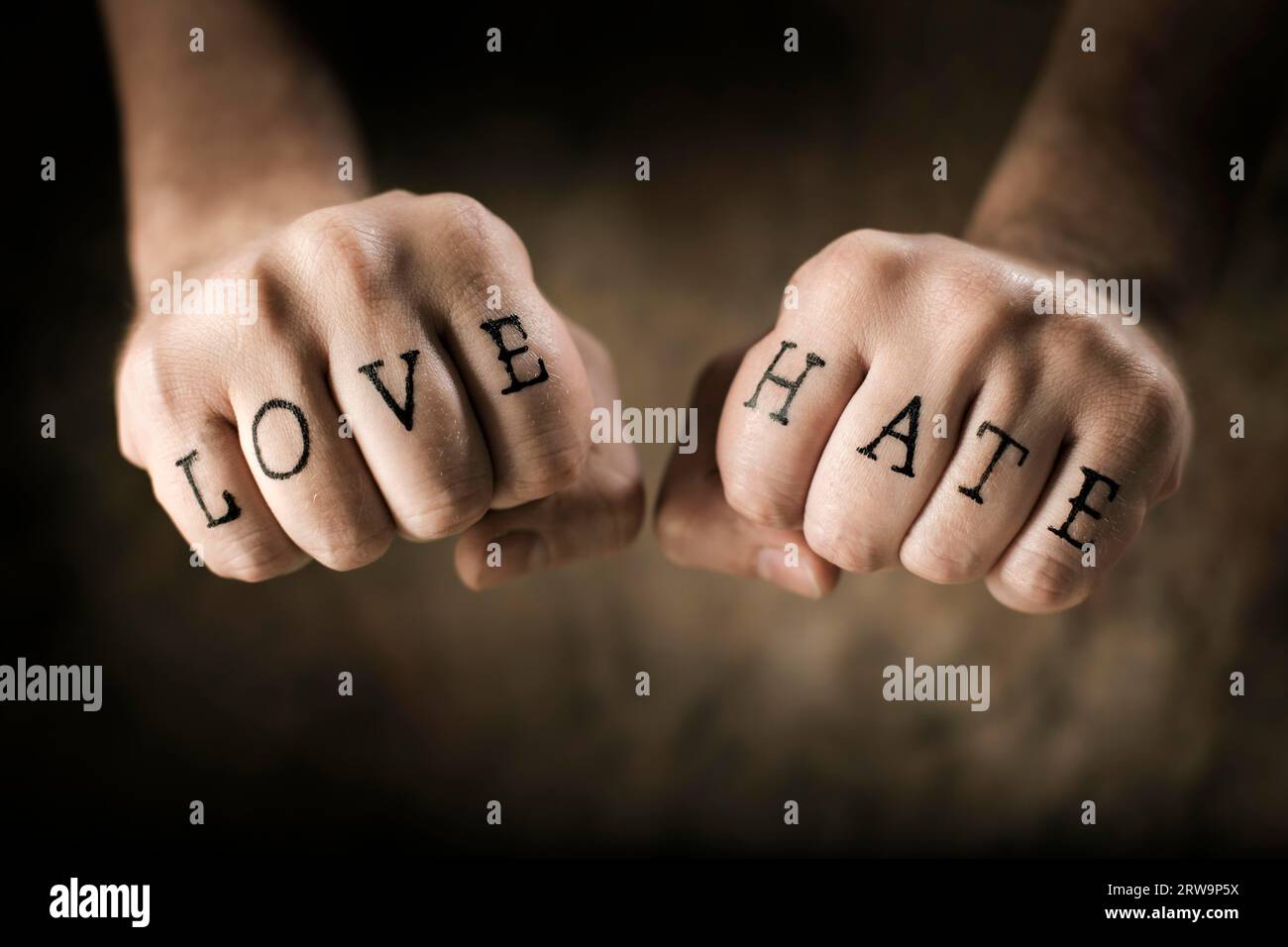 Man with (fake) Love and Hate tattoos on his hands Stock Photo