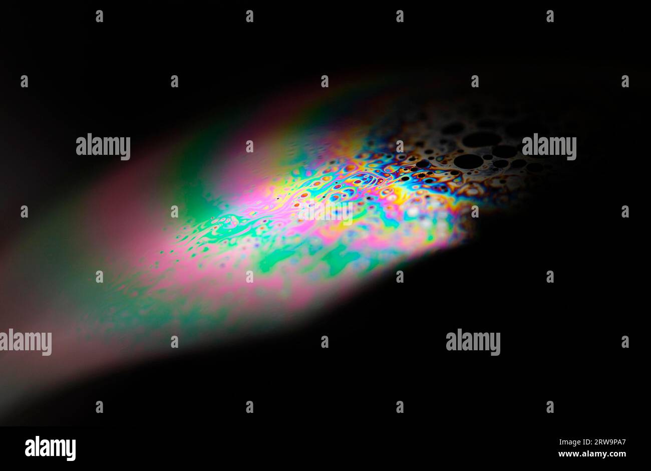 Closeup of a soap bubble. The iridescent colours of soap bubbles are