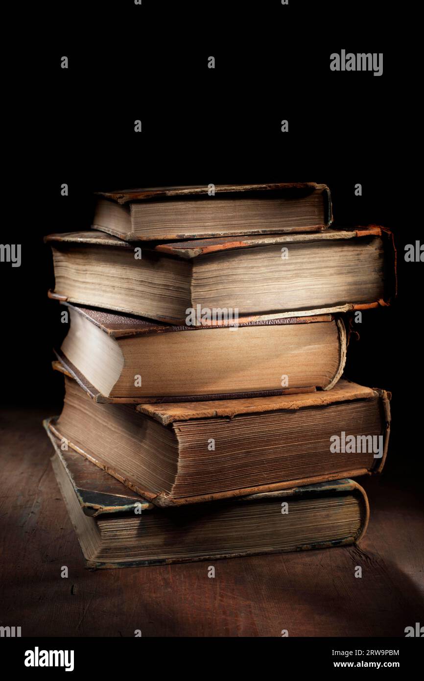 Dark and moody still life with worn and tattered old books Stock Photo ...