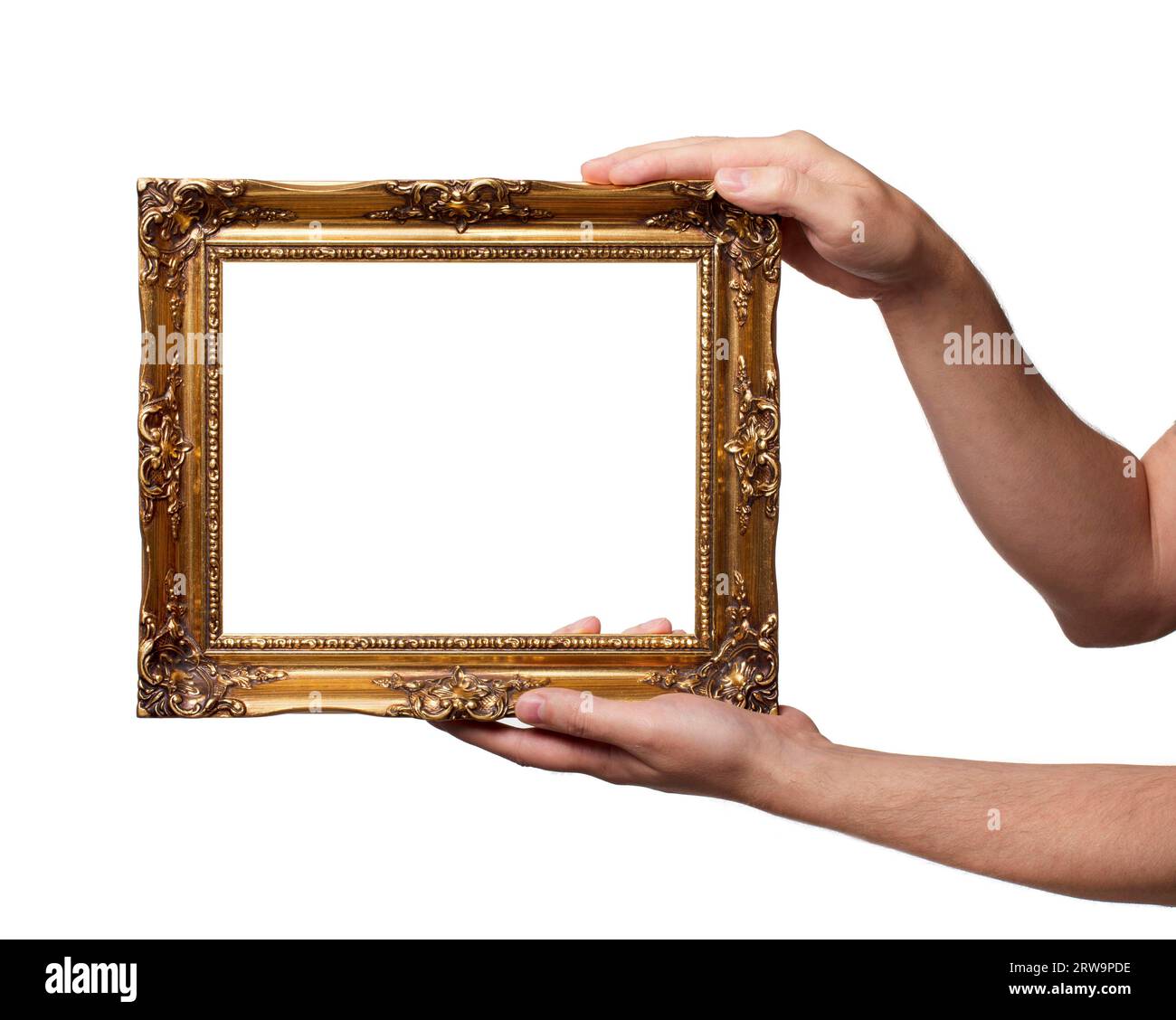 Man holding antique style golden color picture frame in his hands Stock Photo