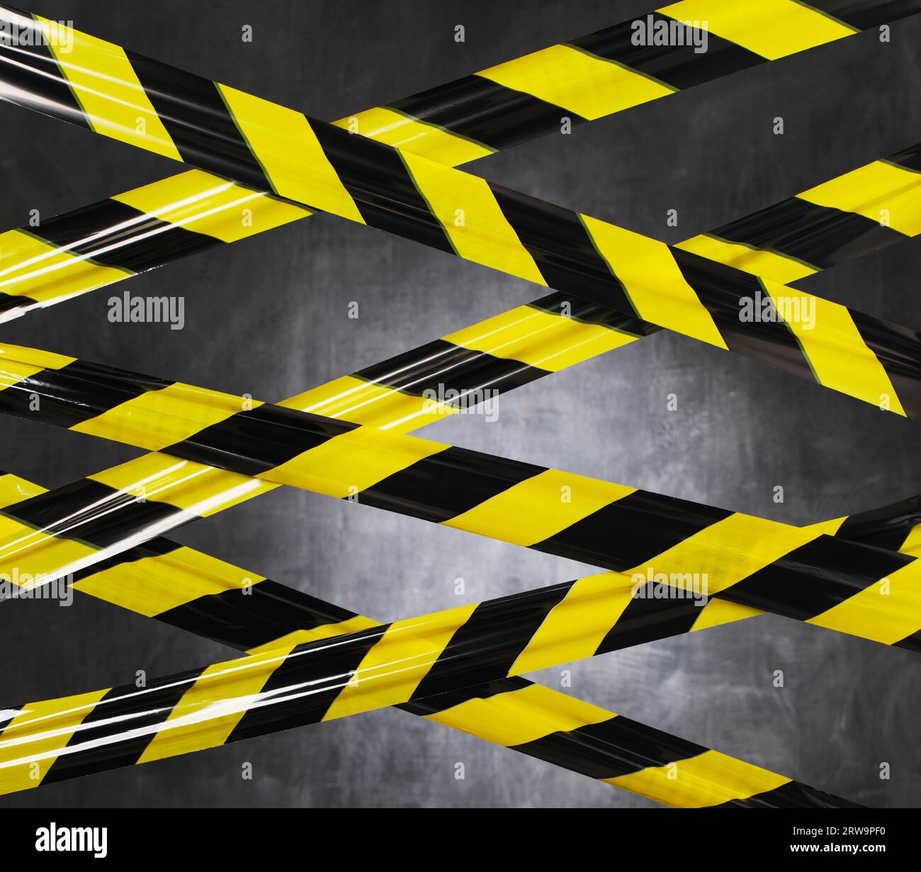 Black and yellow plastic barrier tape blocking the way Stock Photo