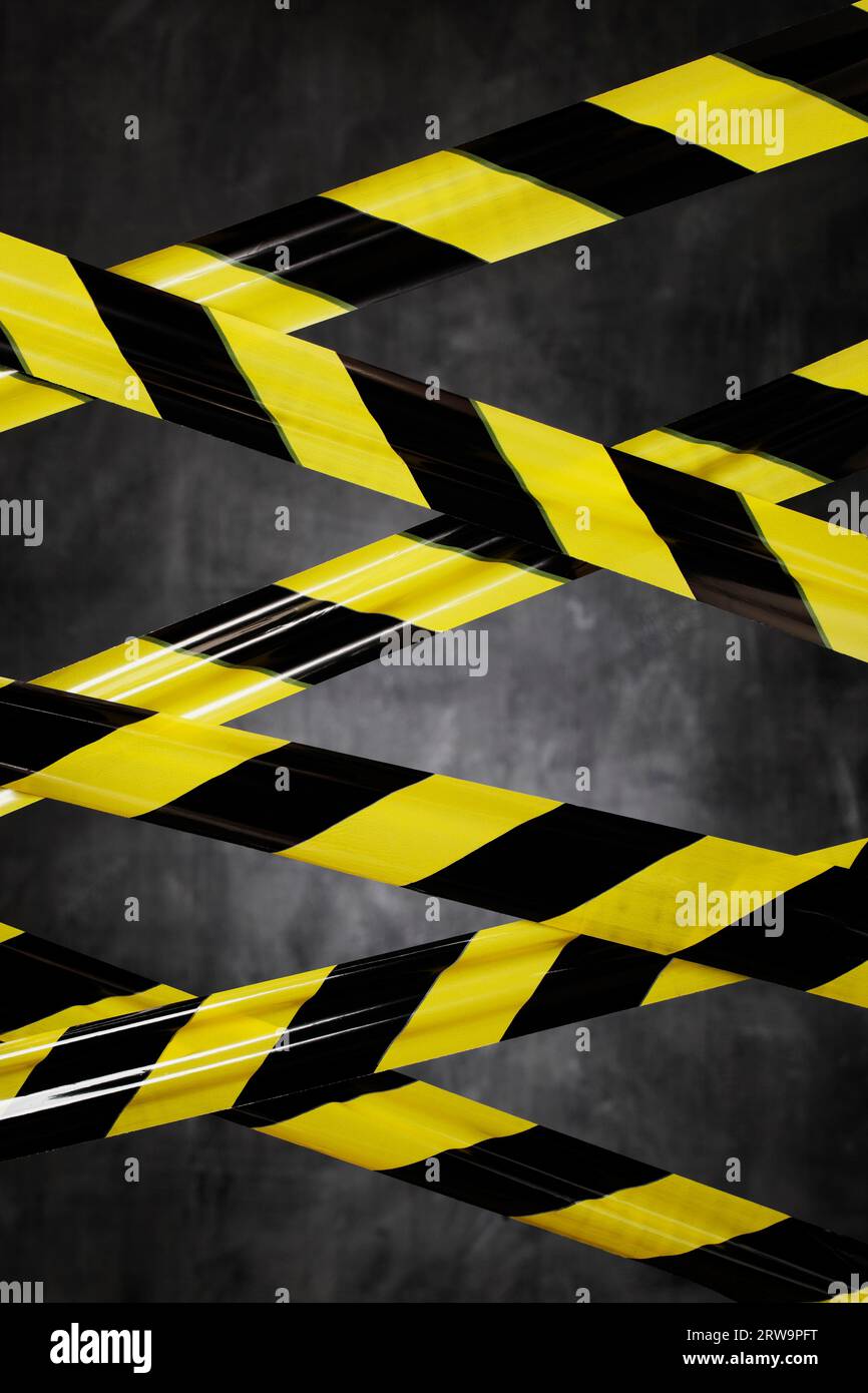 Black and yellow plastic barrier tape blocking the way Stock Photo