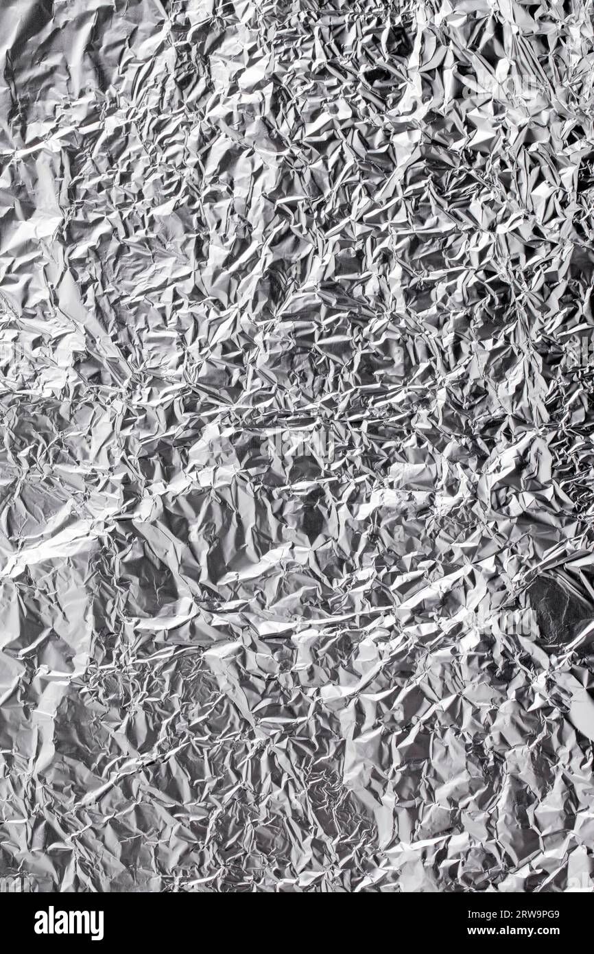 Premium Photo  Close-up of crumpled silver aluminum foil texture in red  tone. abstract background, use for design.
