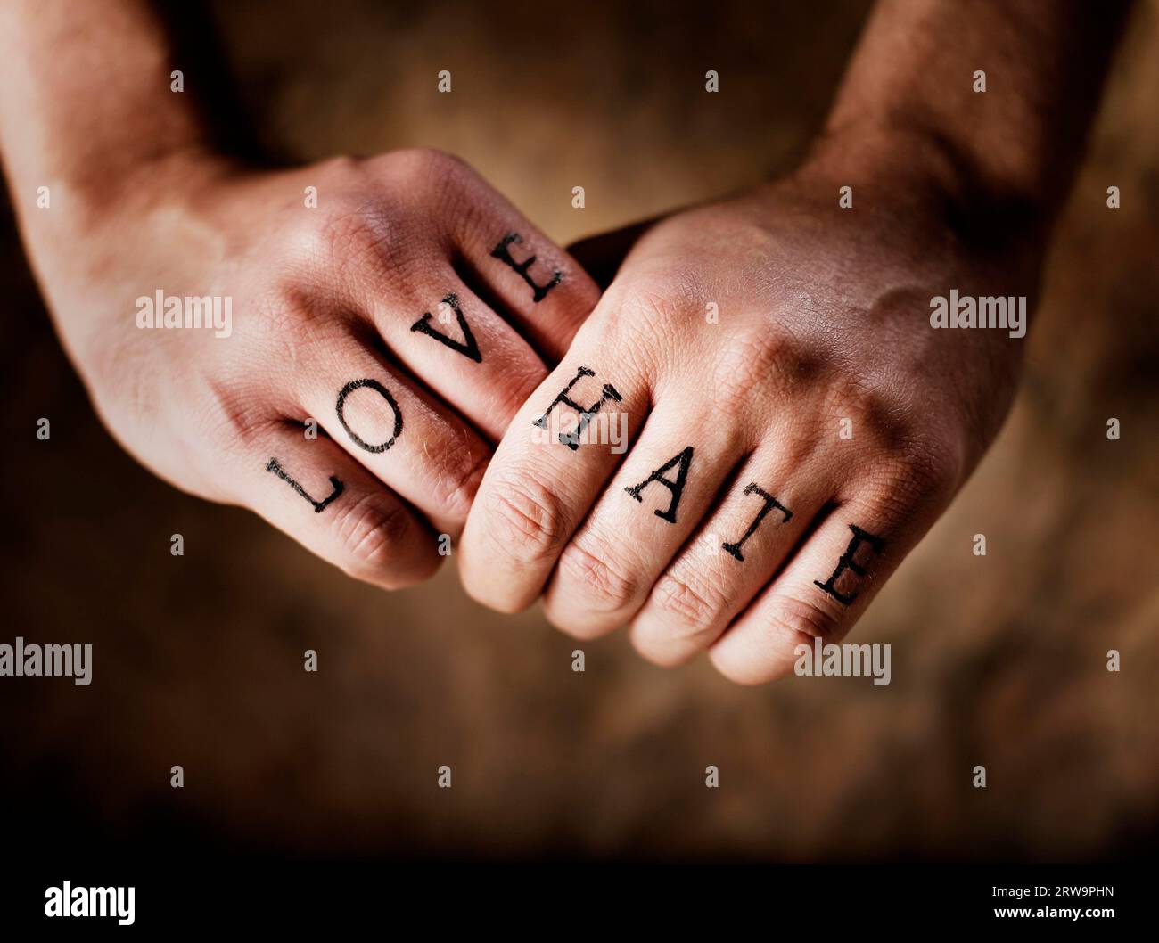 Man with (fake) Love and Hate knuckle tattoos Stock Photo