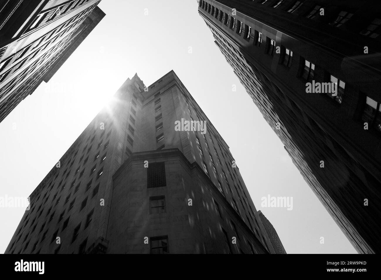 Black and white image of tall buildings on Wall Street, New York City