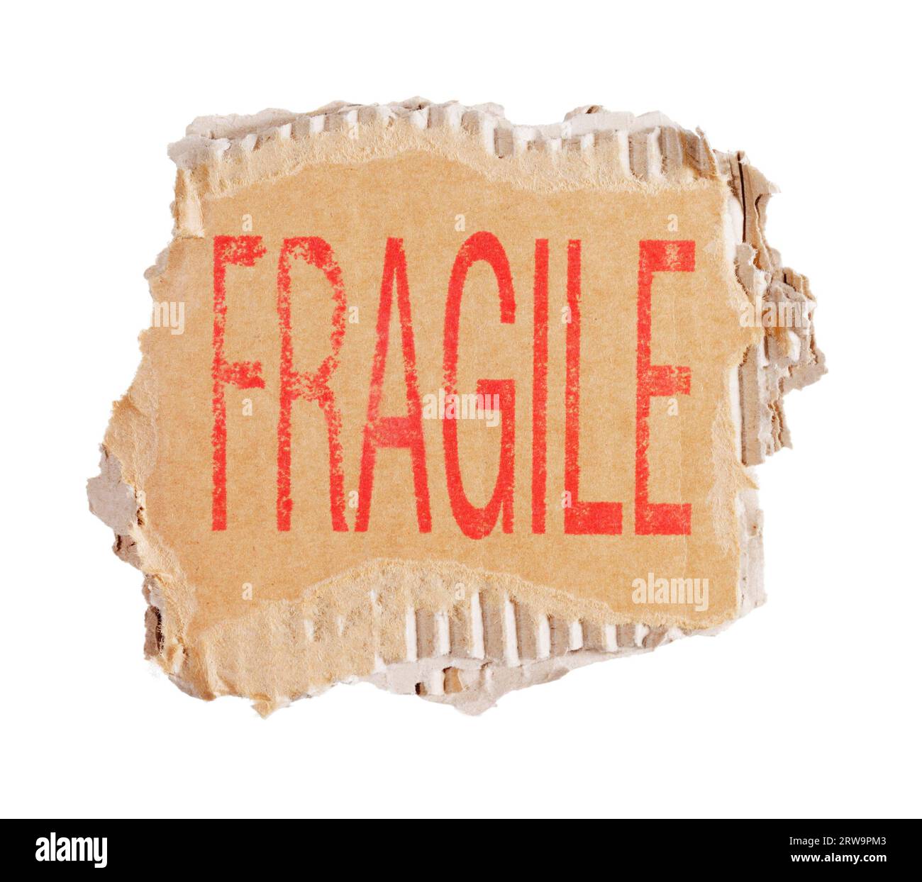 Word Fragile stamped on a piece of brown corrugated cardboard Stock Photo