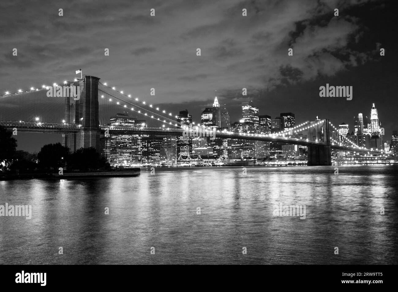 Brooklyn Bridge and Manhattan at night. Black and white Stock Photo