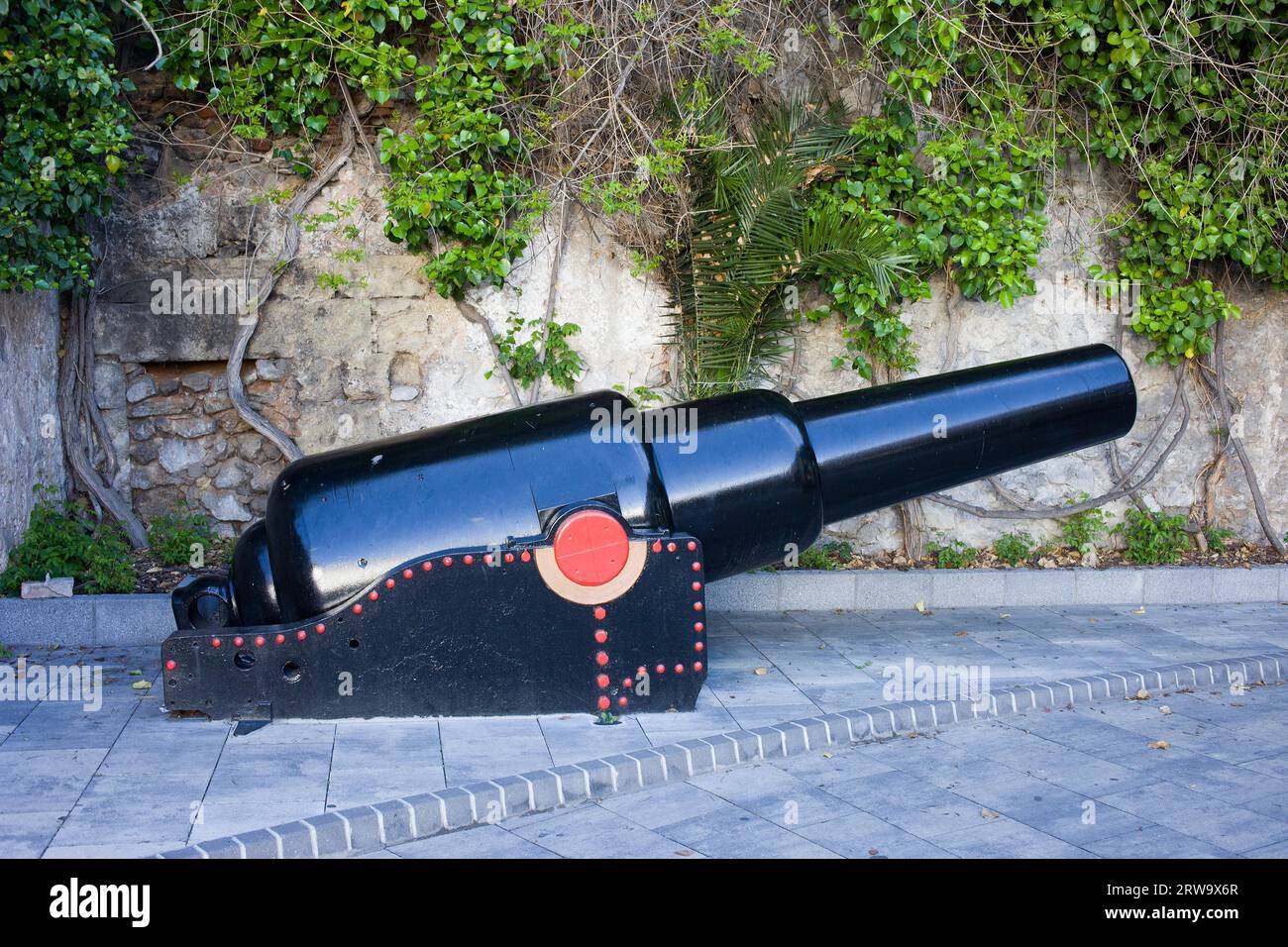 Old naval cannon on a sidewalk in Gibraltar Stock Photo