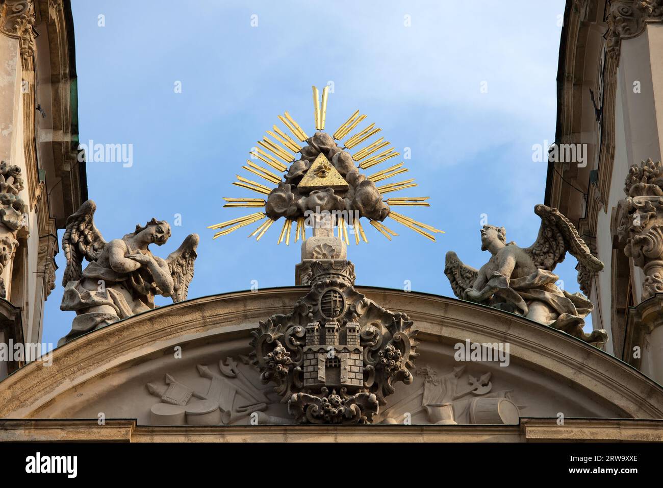 The Trinity Symbol between two angels and Buda's Coat of Arms in Tympanum of Baroque, 18th century Saint Anne Church in Budapest, Hungary Stock Photo