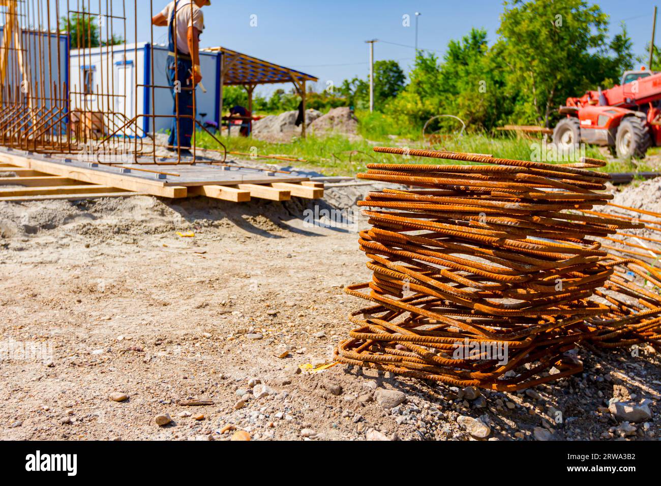 Pile of rusty bent quadratic reinforcement bars placed at the ...