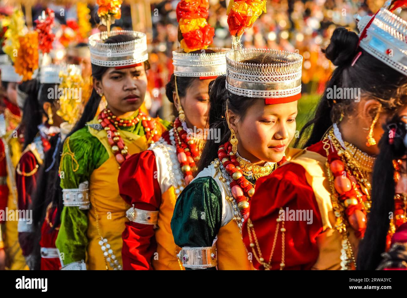 Shillong, Meghalaya, circa April 2012: Young girls wear traditional colourful costumes with large necklaces during Shad Suk Mynsiem Festival in Stock Photo
