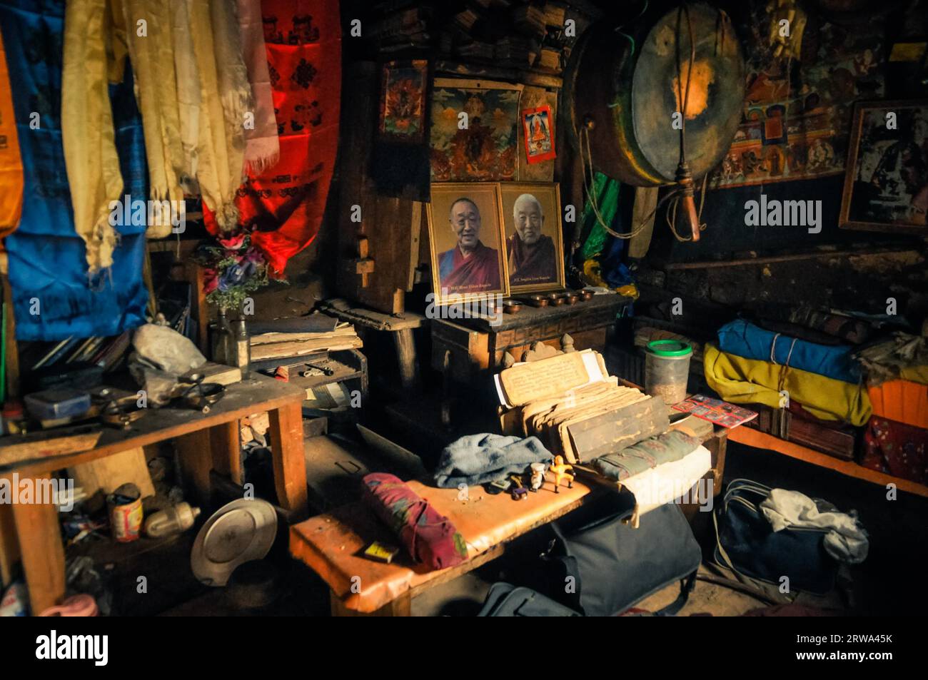 Dolpo, Nepal, circa June 2012: Photo of room with many things such as portraits of famous monks, bags and small boards with writing and other things Stock Photo