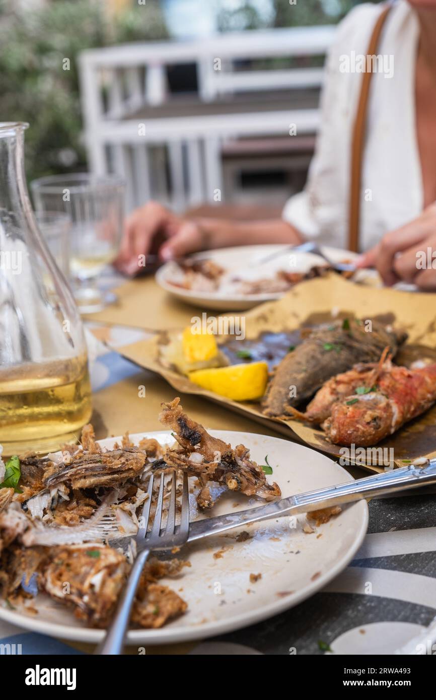 Fish bones are left after finishing the meal at the restaurant Stock Photo