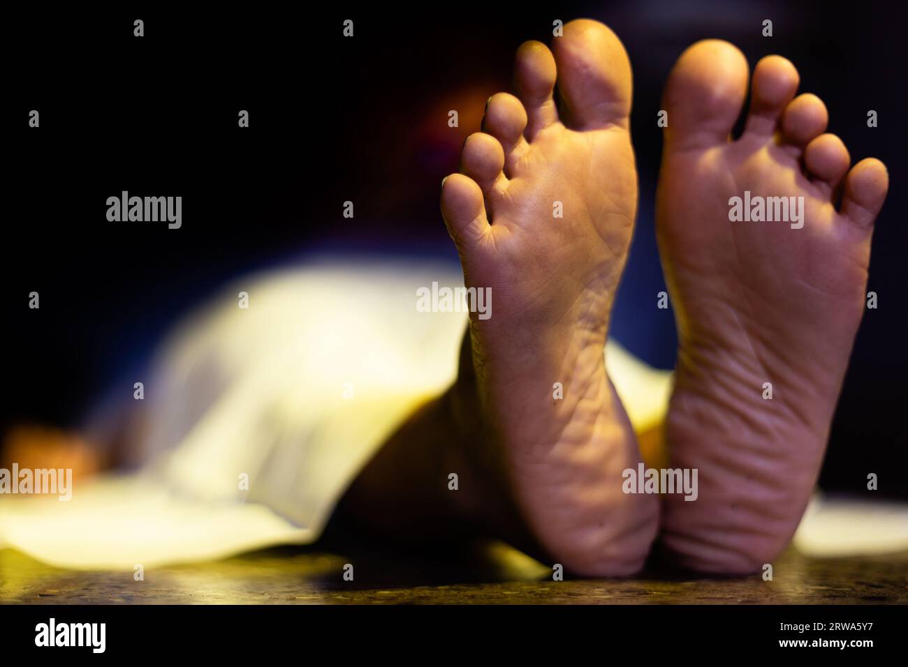 Feet of an Indian or Asian female dead body lying on floor in a dark room  Stock Photo - Alamy