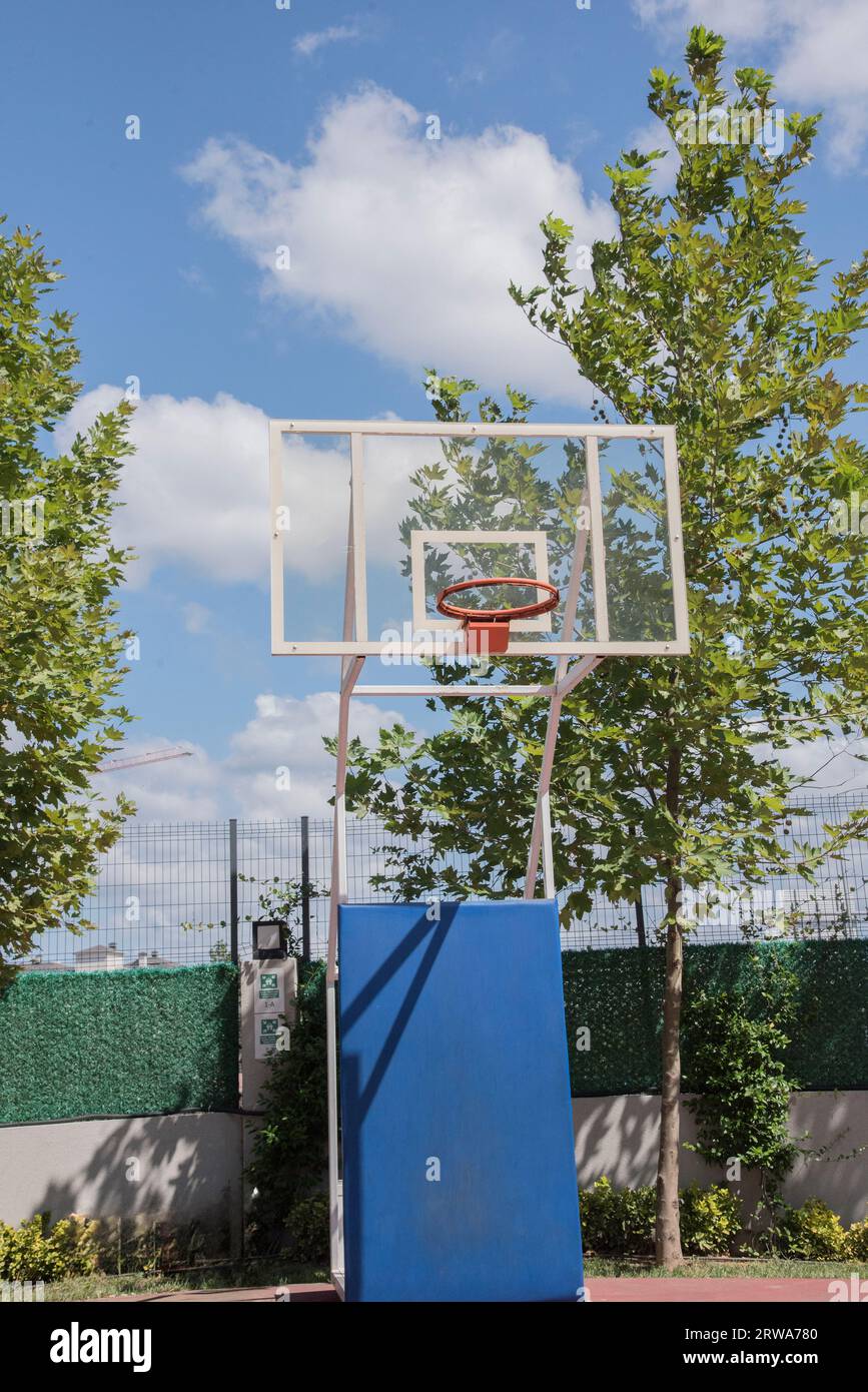 Basketball court outdoors, orange hoop, net and backboard for basket ball game outside in school garden.Turkey,Istanbul Stock Photo
