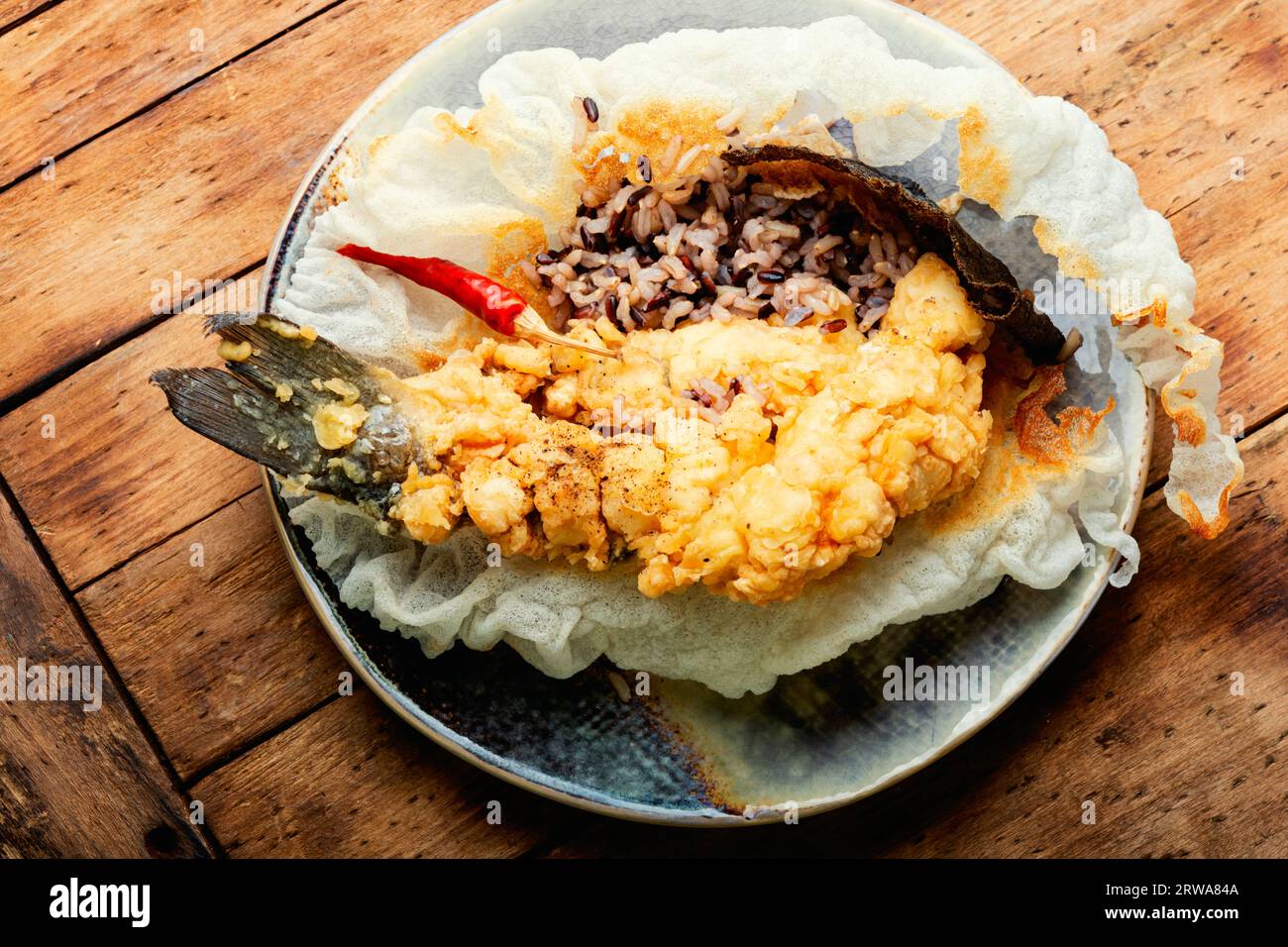 Breaded dietary fish and wild rice. Deep fried fish Stock Photo Alamy