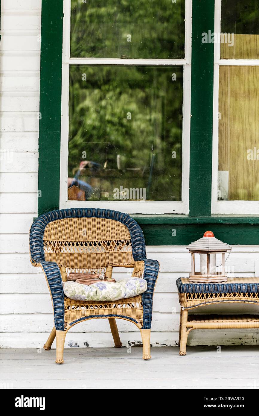 Empty chair and table on a wooden porch. Stock Photo