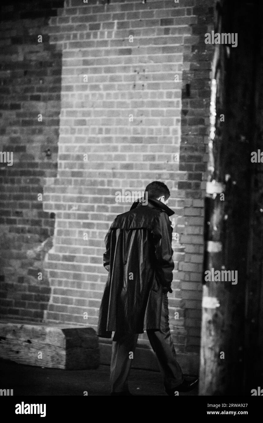 Rear view of a man wearing a long coat Stock Photo - Alamy