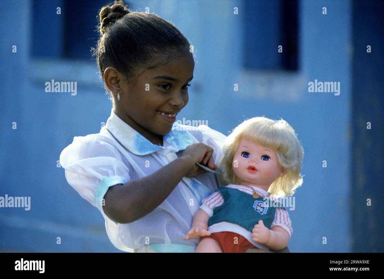 Rio de Janeiro - Brazil South America; Black girl with blond doll Stock Photo