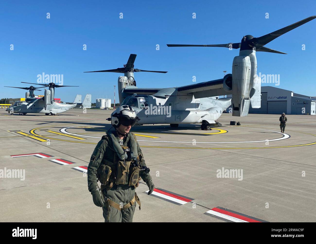 Riga, Latvia. 18th Sep, 2023. A pilot stands in front of an MV-22 Osprey aircraft at Riga Airport. The maneuver is a German Navy exercise and is intended to strengthen cooperation between countries in the Baltic Sea region. Fourteen countries are taking part in the exercise. Credit: Alexander Welscher/dpa/Alamy Live News Stock Photo