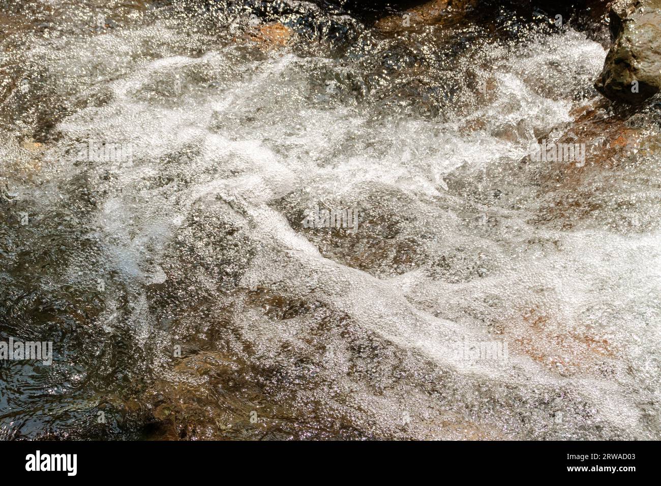 Water flowing over rocks in a stream. After some edits Stock Photo - Alamy