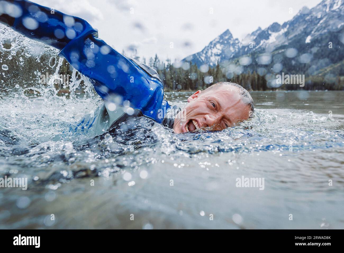 A middle aged male diver surfaces to take a breath. Stock Photo