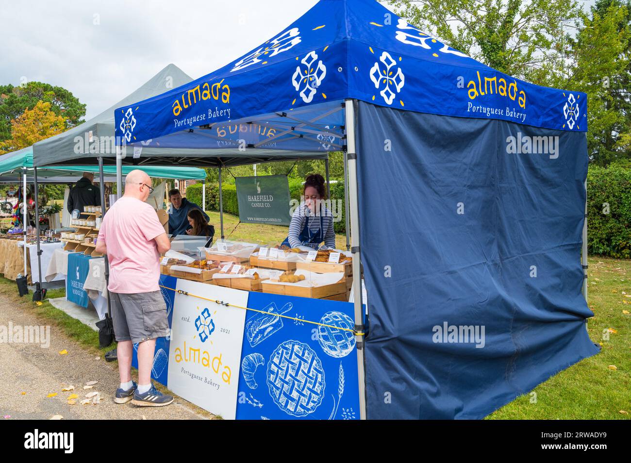 Man buying from Almada Portuguese Bakery stall at Duckpond Market craft