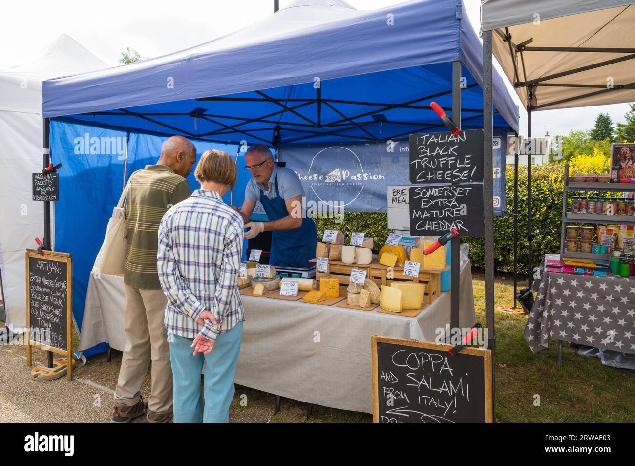 Customers buying cheese from Cheese Passion artisan cheesemonger stall