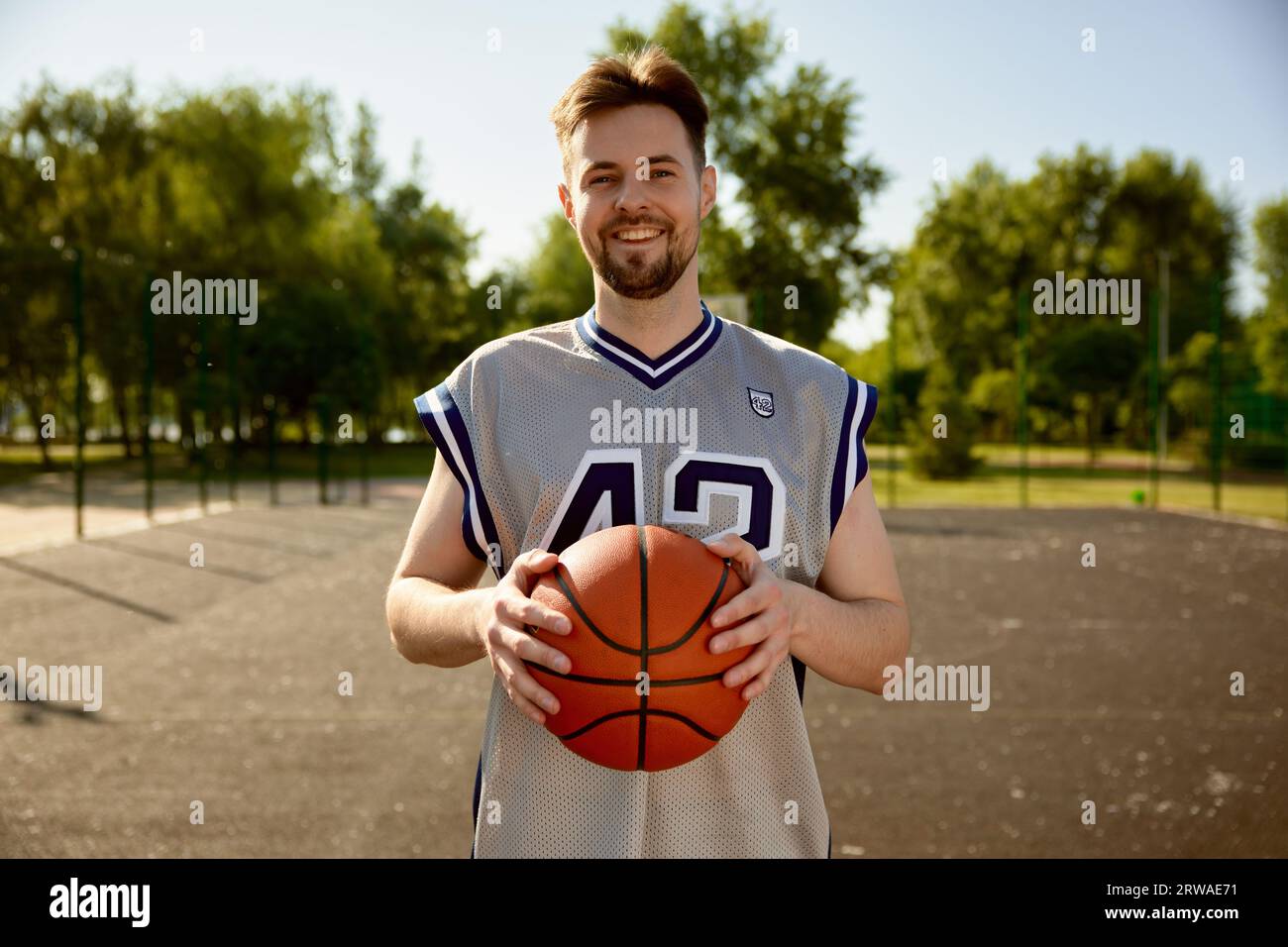 Headshot portrait of smiling happy basketball player looking at camera Stock Photo