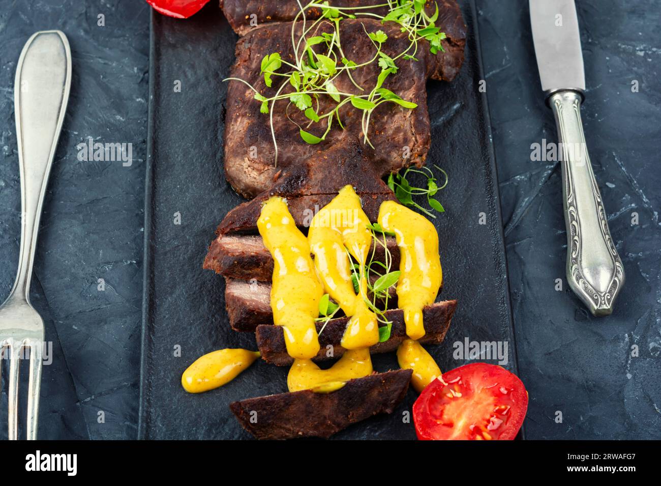 Roasted ostrich meat steaks with sauce. African cuisine Stock Photo Alamy