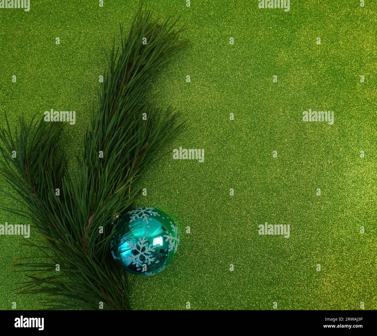 green christmas background with fir tree branch and christmas balls and ...
