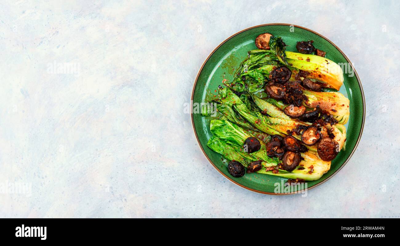 Chinese fried Pak Choi with shitake mushrooms. Asian vegan food. Space