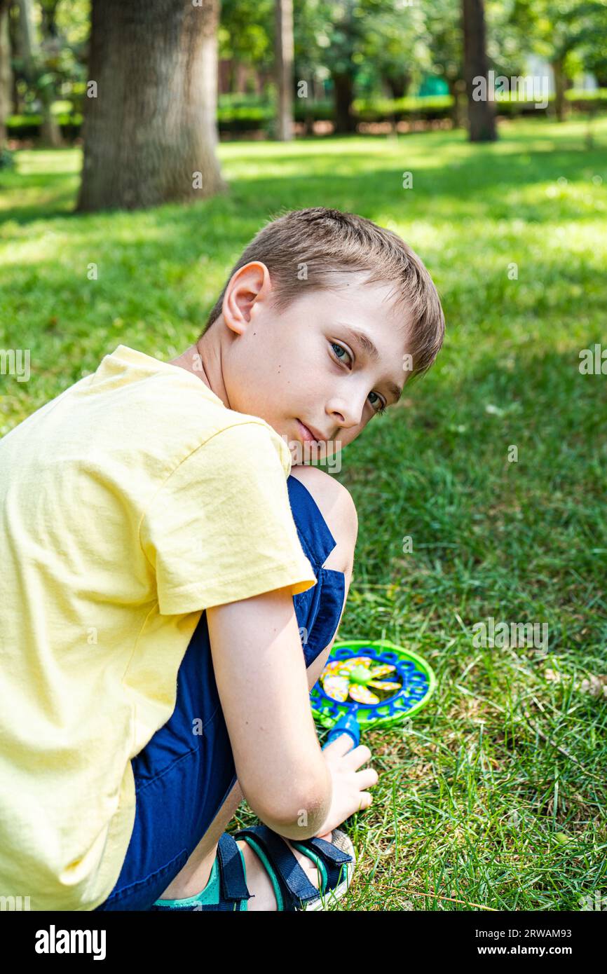 Nice boy playing in the summer park Stock Photo