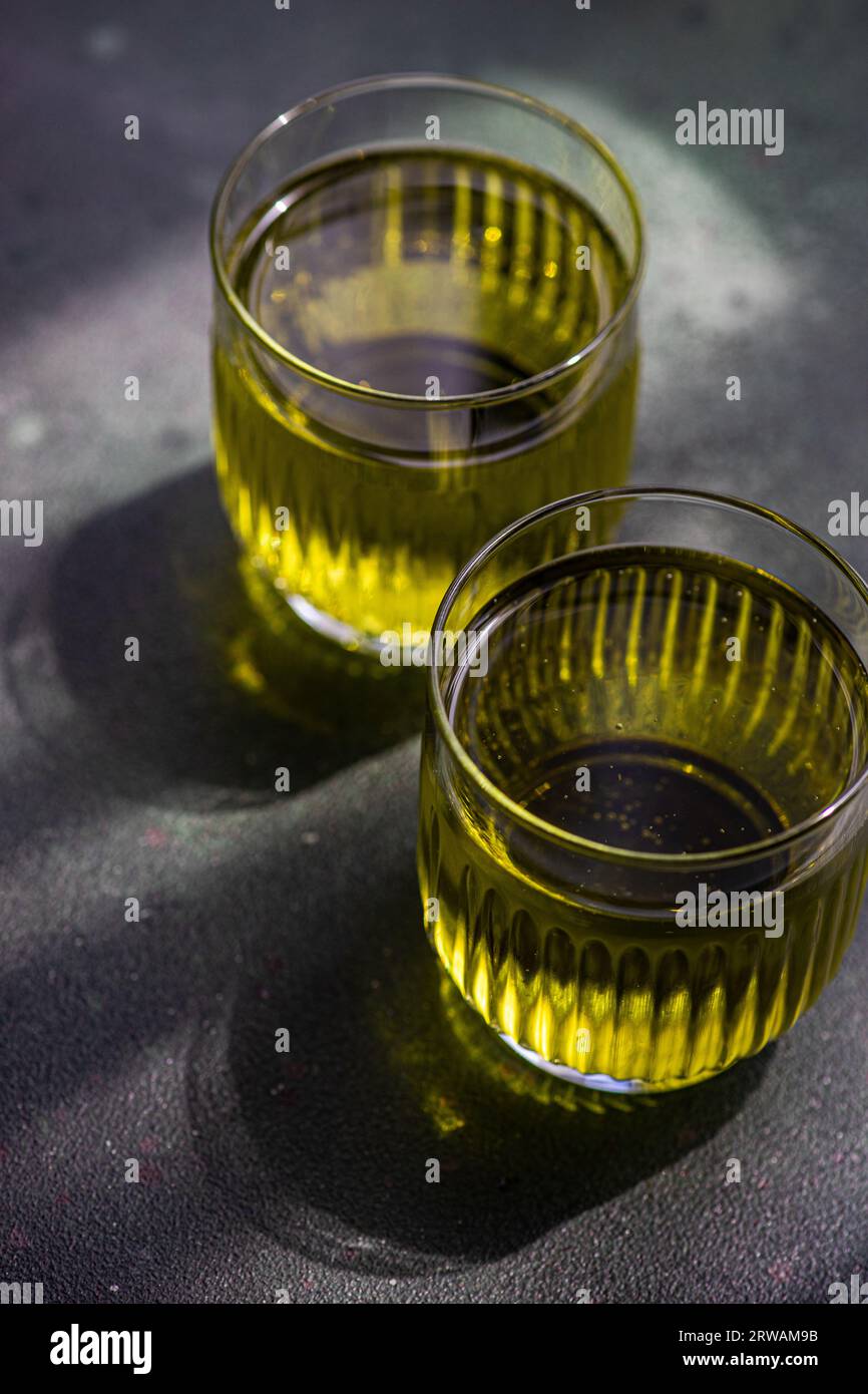 Glasses with tasty feijoa lemonade on dark concrete table Stock Photo