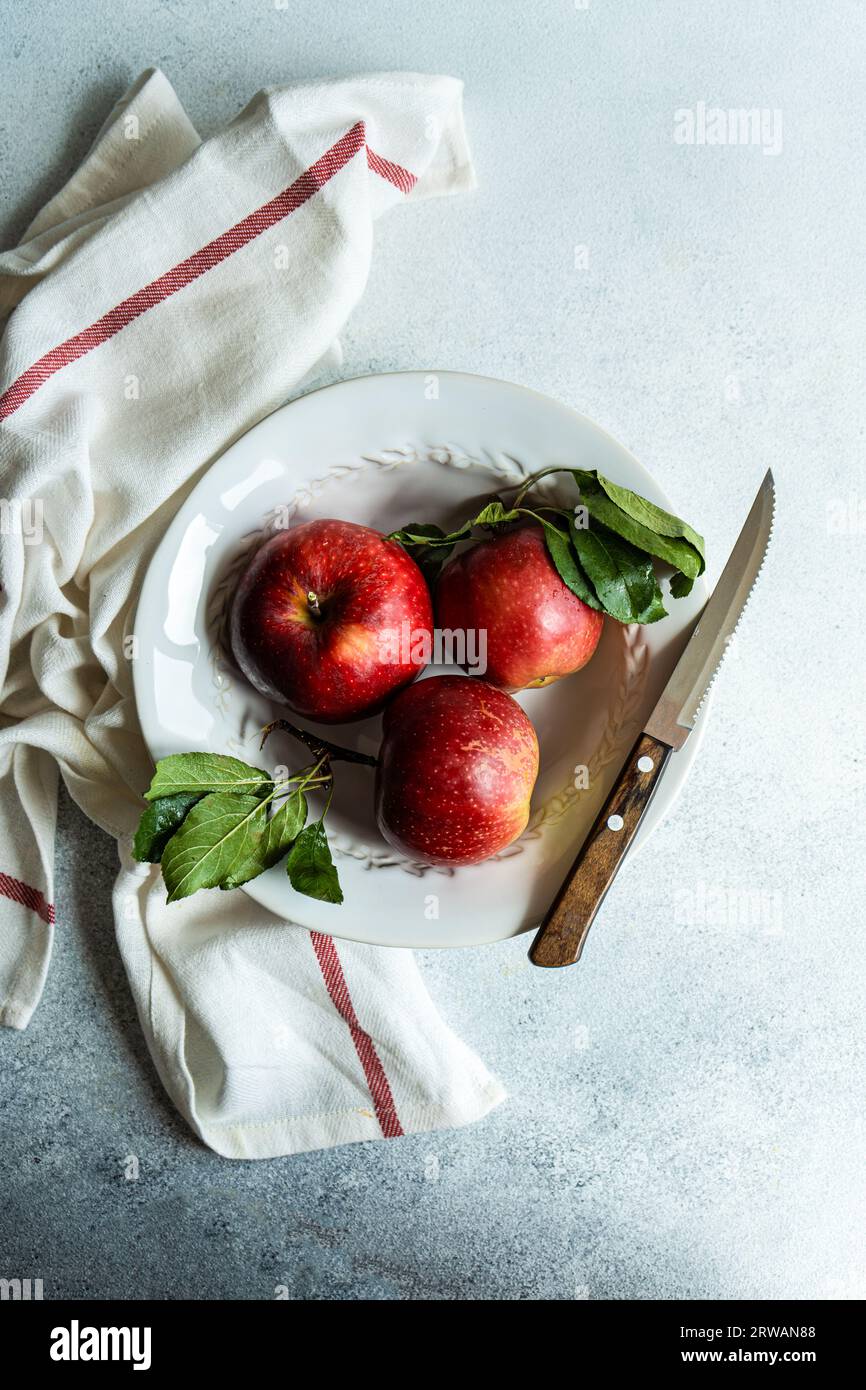 Tasty ripe apples on the plate as a autumnal harvest concept Stock Photo