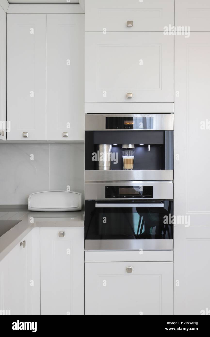 Builtin fully automatic coffee machine in kitchen furniture Stock