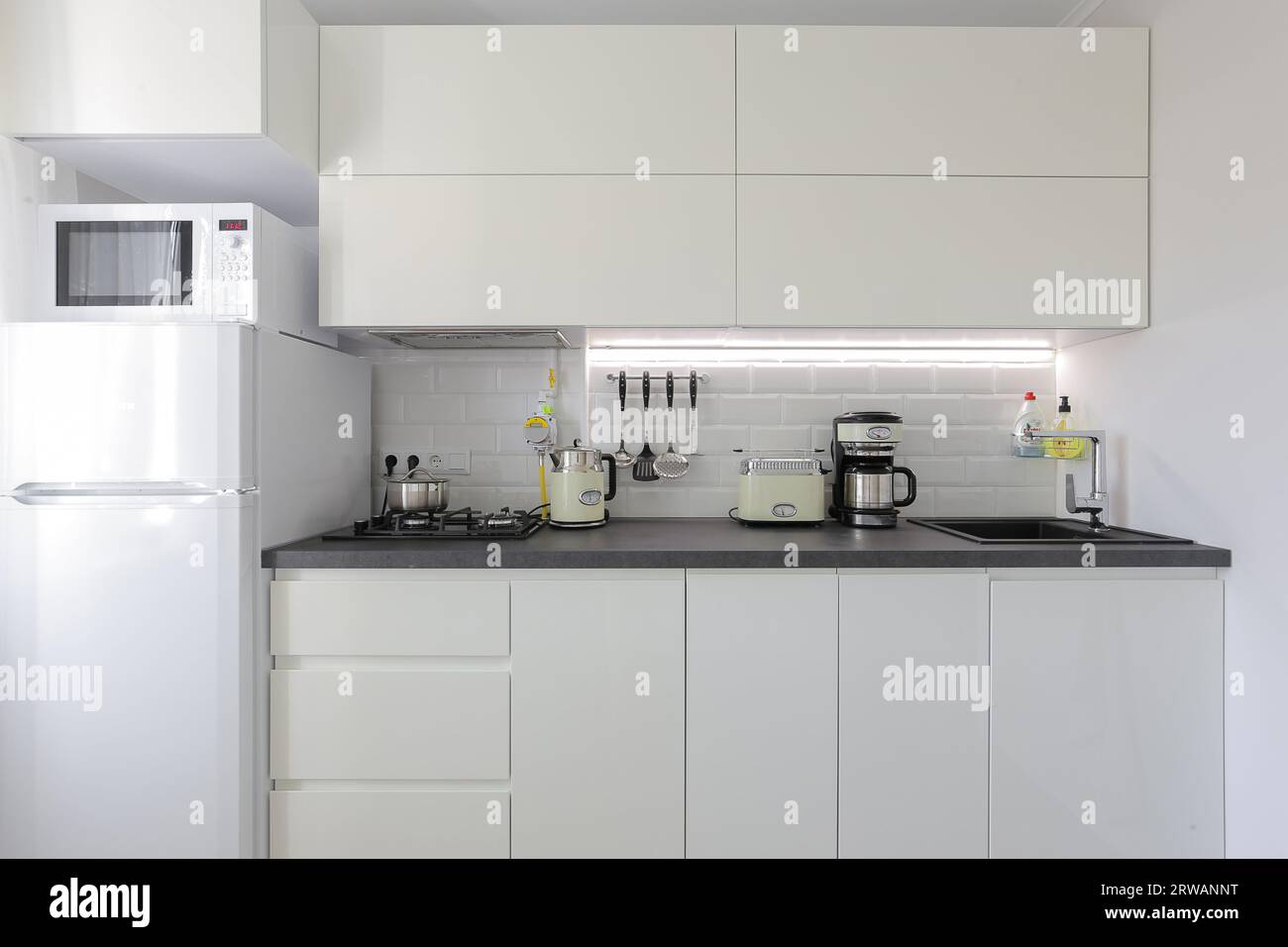 Facade of white kitchen furniture in the kitchen interior Stock Photo