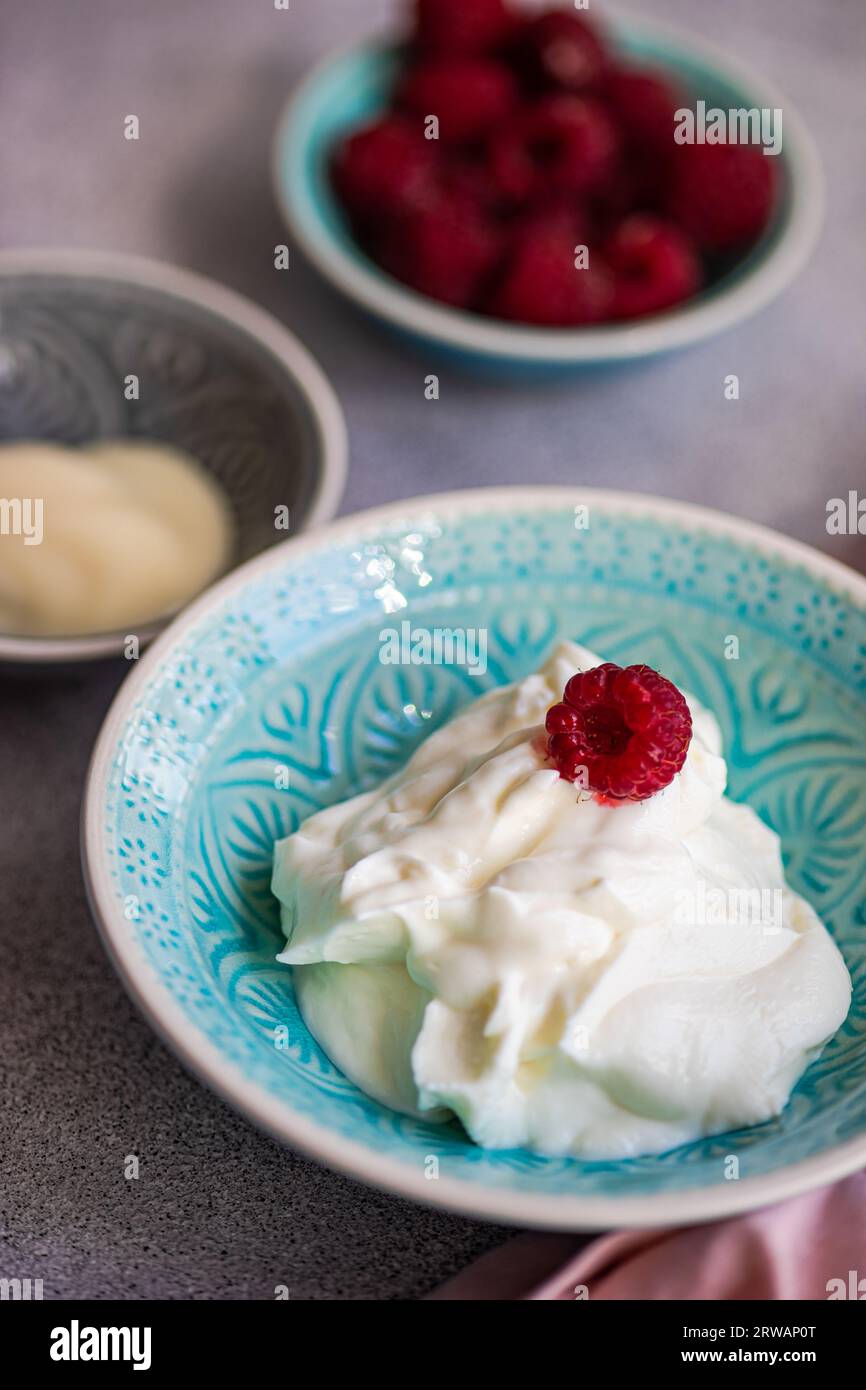 Healthy breakfast with cottage cheese and raspberry and milk on concrete table Stock Photo