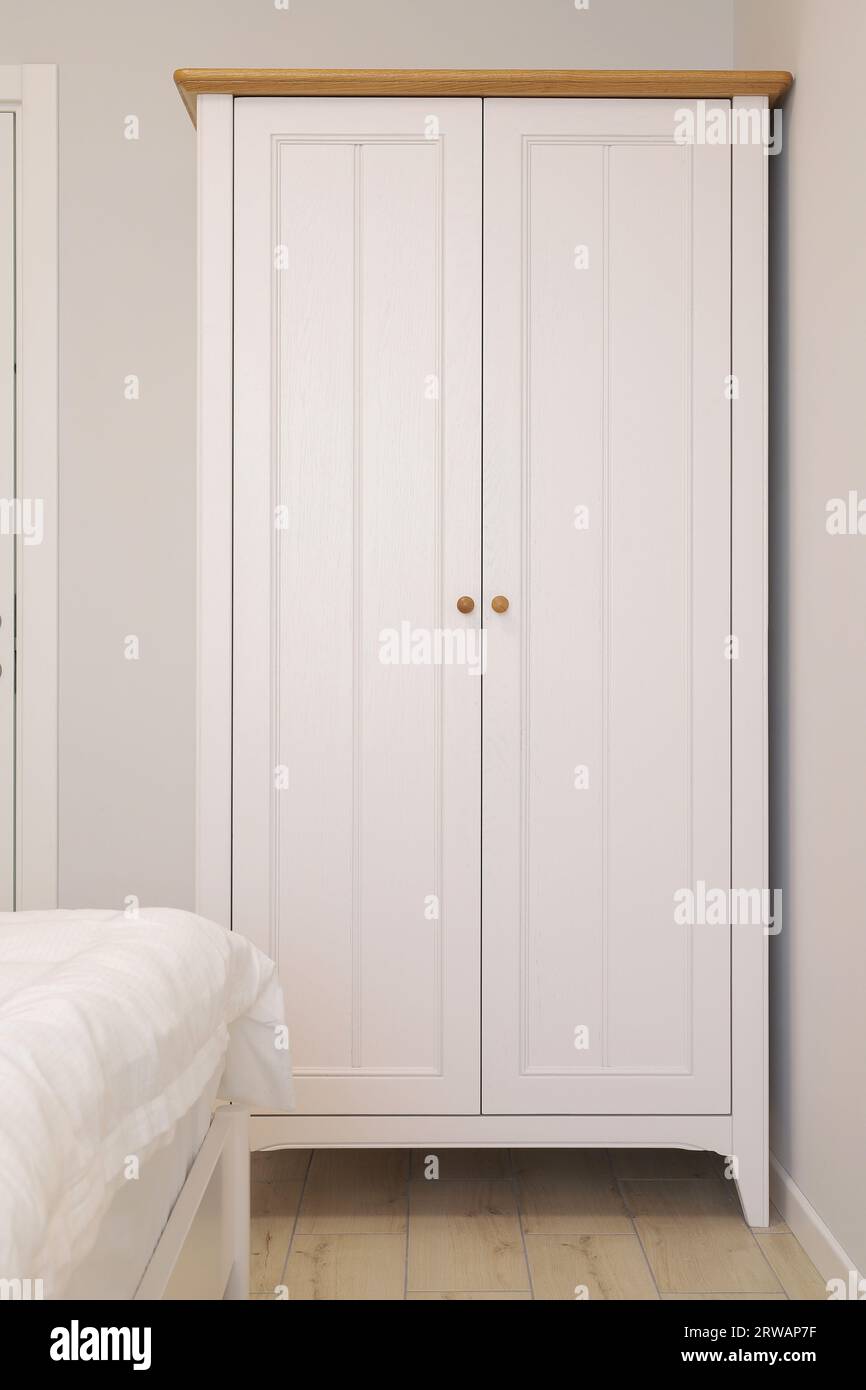 White wooden wardrobe in the bedroom interior Stock Photo