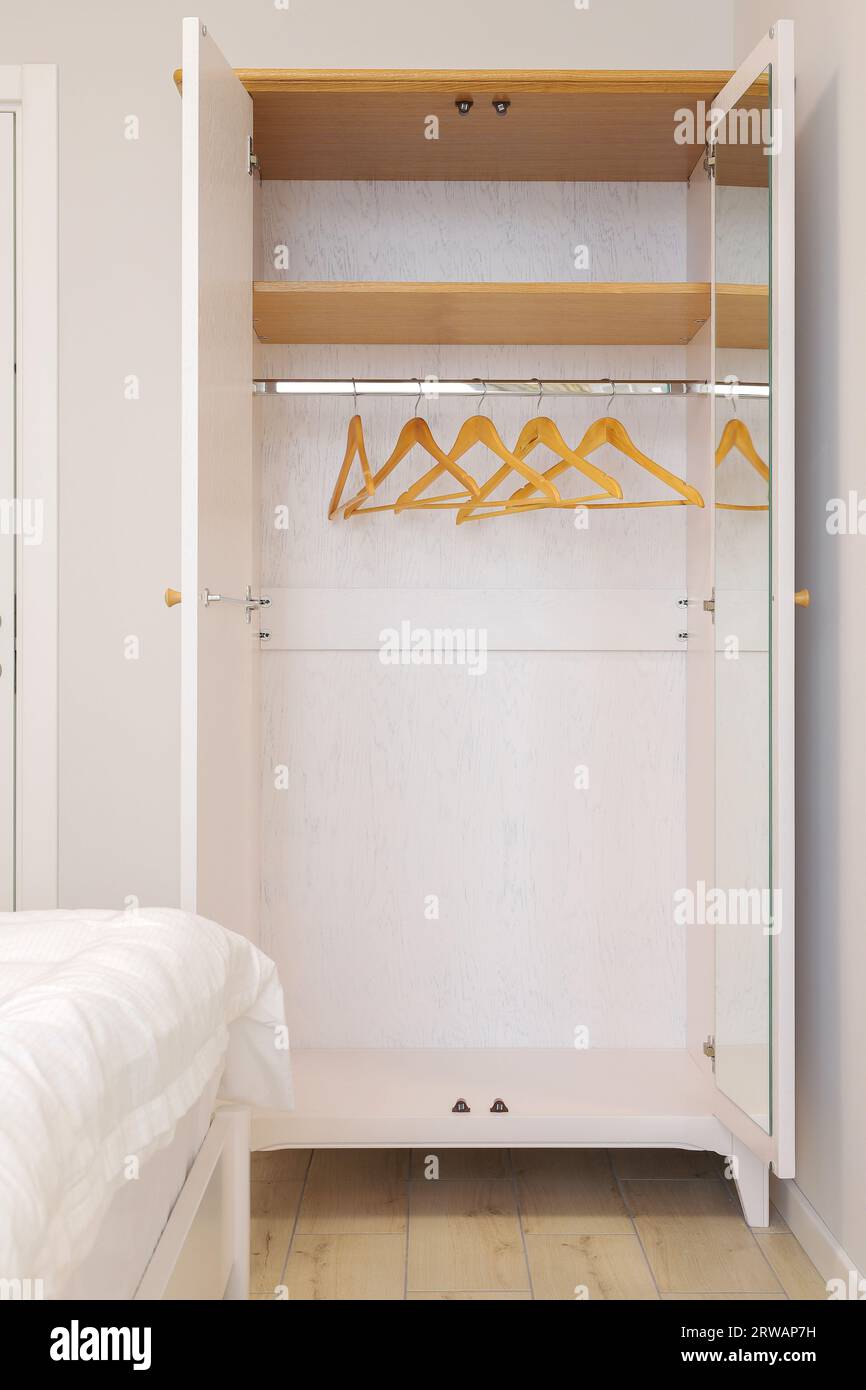 White open wooden wardrobe in the bedroom interior Stock Photo