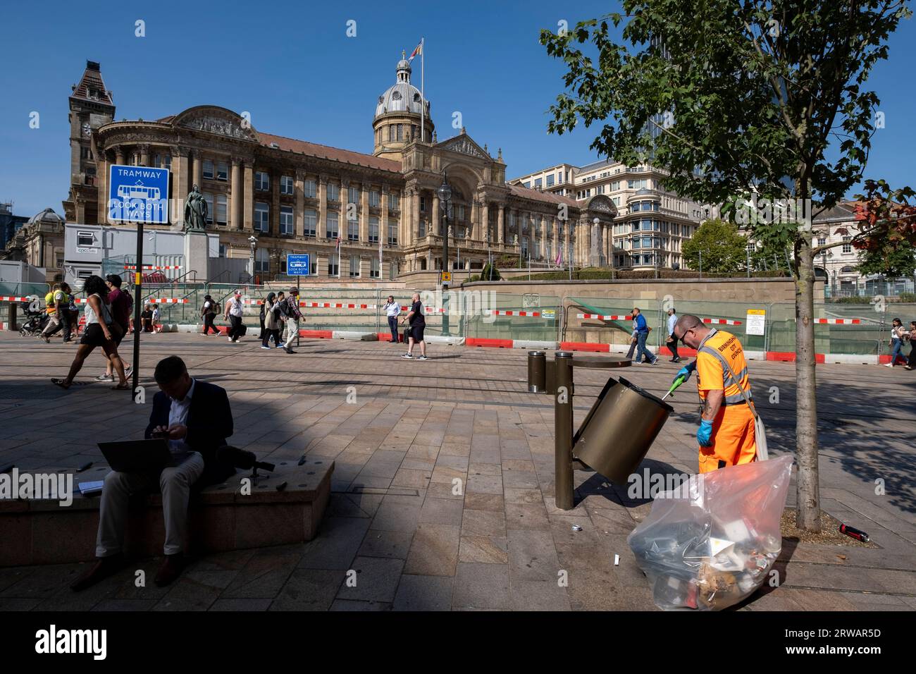 Birmingham City Council refuse collector works emptying the bins