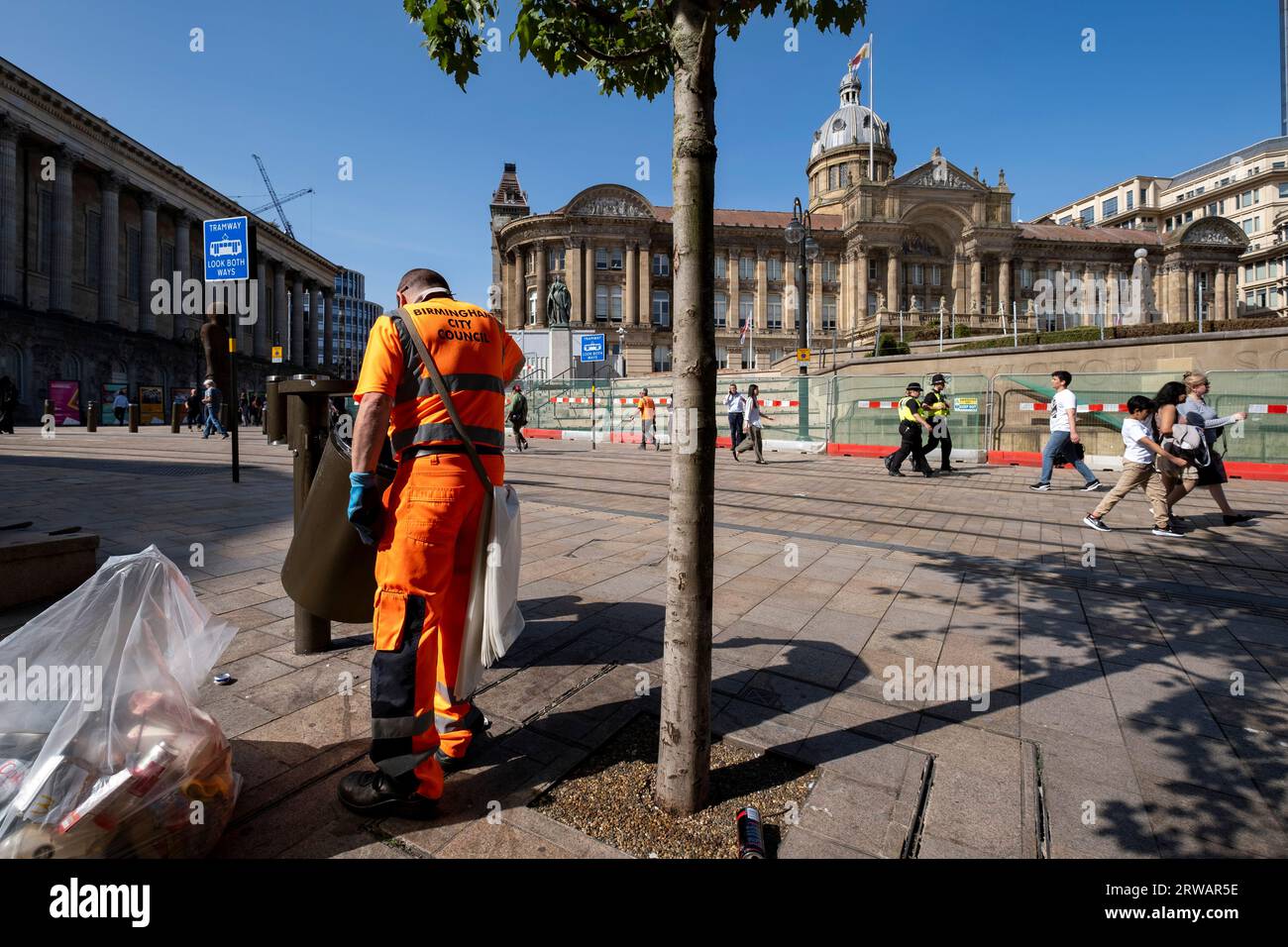 Birmingham City Council refuse collector works emptying the bins