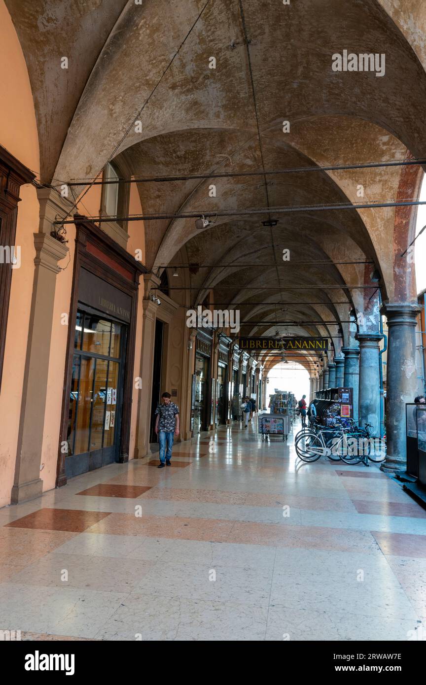 Via de' Musei, covered with a long high ceiling porticos or colonnades with a roof structure over a walkway supported with large arches in the city ce Stock Photo