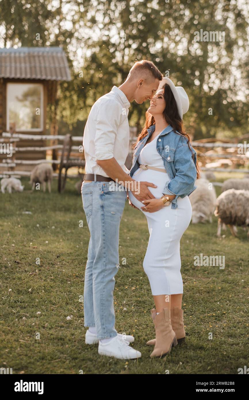 Happy man hugs his pregnant woman's belly at sunset Stock Photo - Alamy