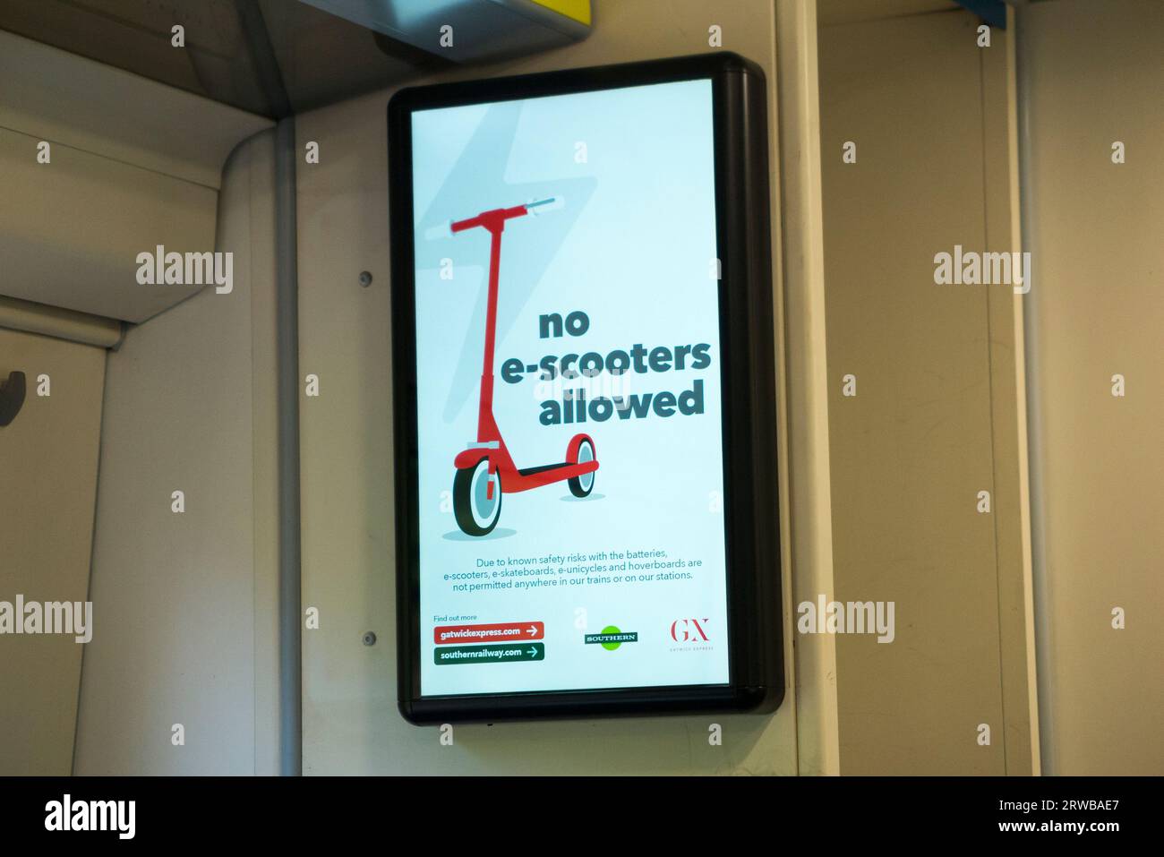 LCD screen sign board on a Southern train informing of e scooter and e bike / e cycle / e bicycle and other electric cycles and scooters. UK. (135) Stock Photo