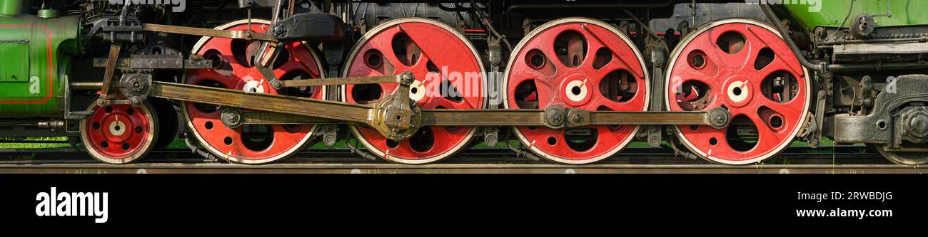 Group of red wheels and steel machinery of antique steam locomotive Stock Photo
