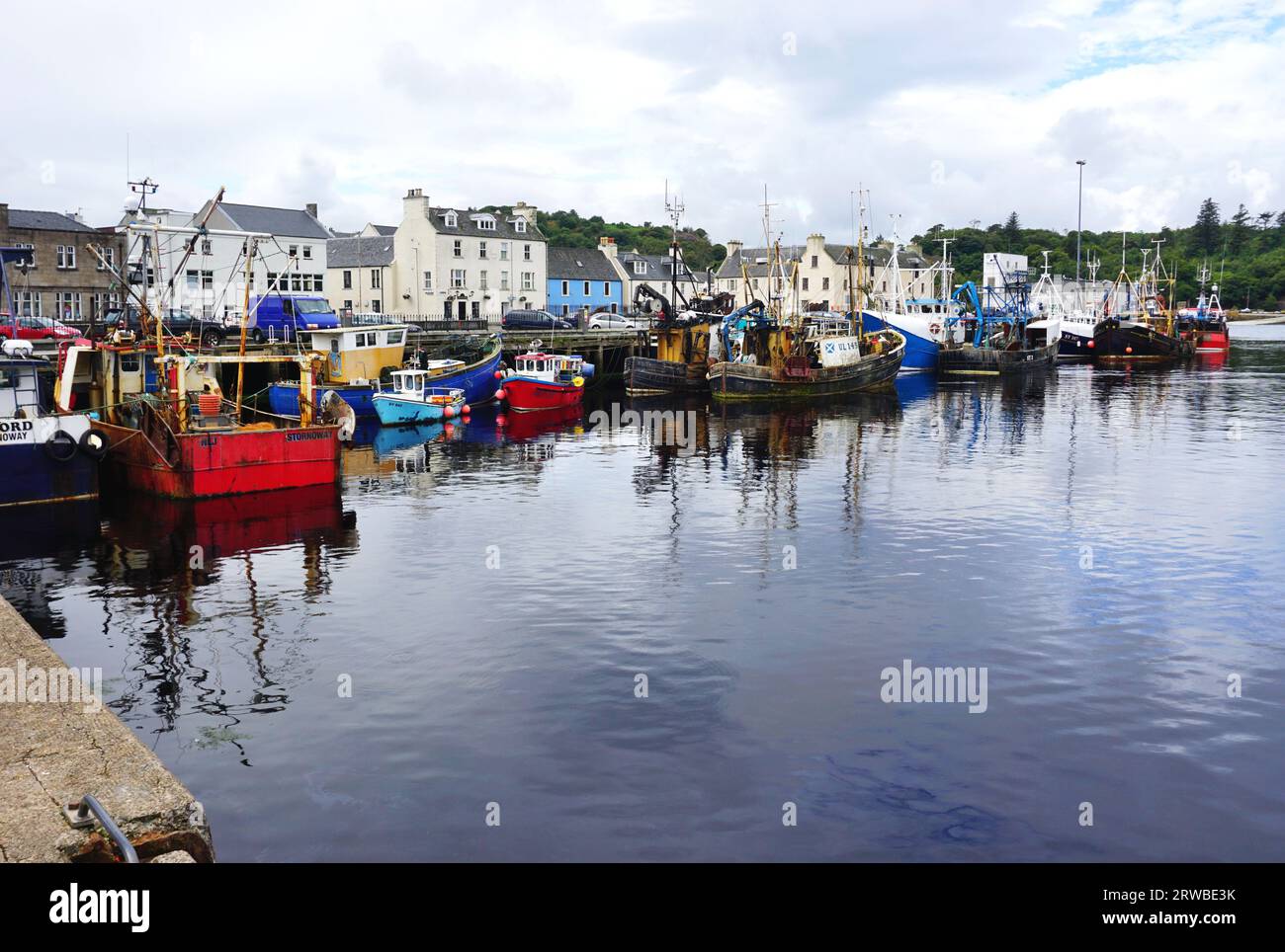 Broad view of the busy harbor at Stornoway, Isle of Lewis, in Scotland's Outer Hebrides. The harbor receives regular visits from the ferry to Ullapool Stock Photo