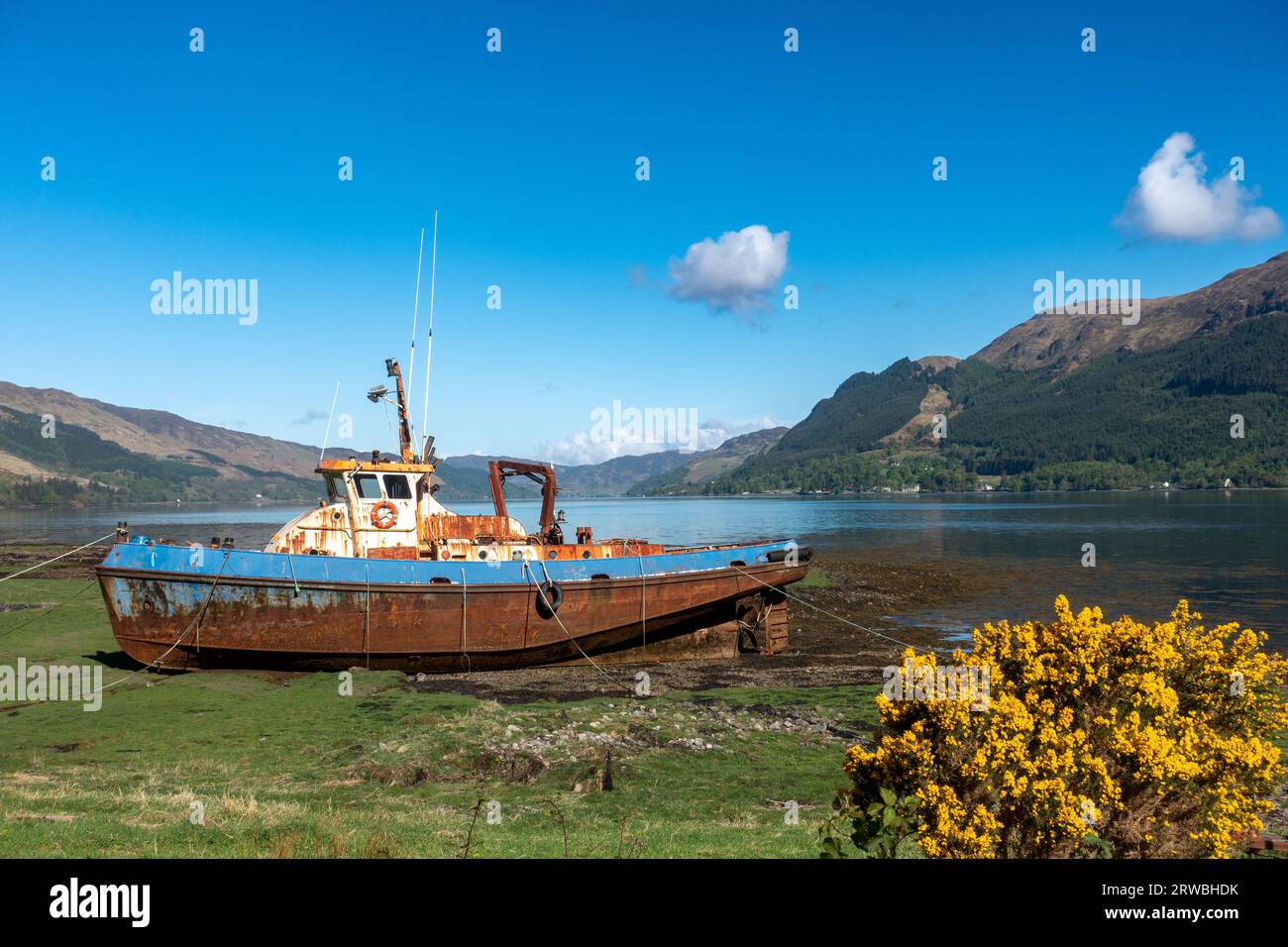 Old fishing boat on shore of Loch Duich near Ratagan and Glen Shiel in Scotland Stock Photo