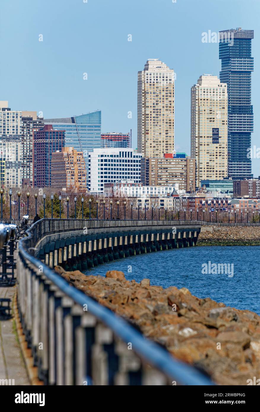 The Liberty State Park walkway, spanning the Hudson Riverfront from Black Tom Island to the CRRNJ Terminal, offers a view of the Jersey City skyline. Stock Photo