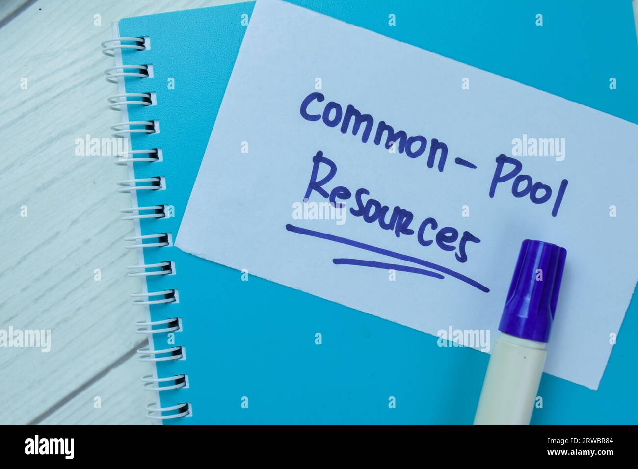 Concept of Common-Pool Resources write on sticky notes isolated on Wooden Table. Stock Photo